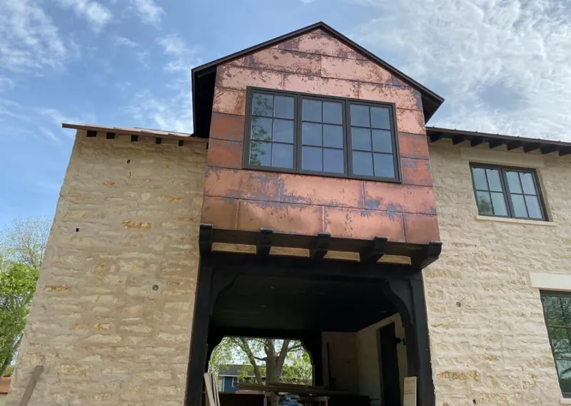 Copper metal panel facade on a stone building for Skylight Installation in South Gate Ridge